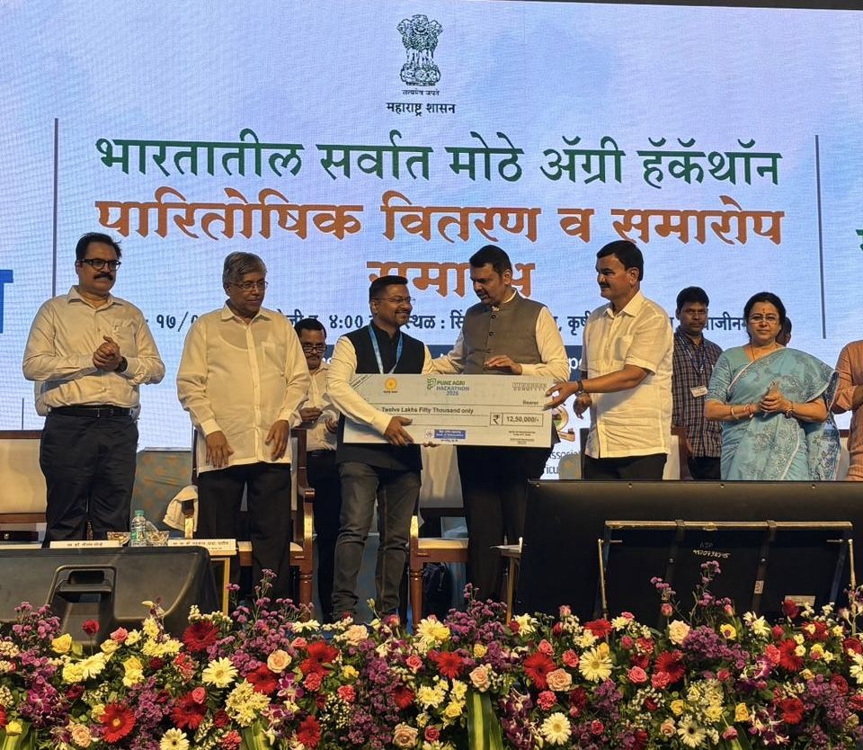 Founder receiving the Pune Agri Hackathon 2026 winning prize cheque from the Chief Minister of Maharashtra on stage